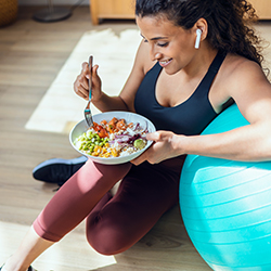 Sporty young woman eating healthy food